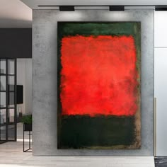 an abstract painting hangs on the wall