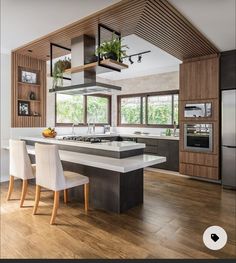 a modern kitchen with an island and wooden cabinets