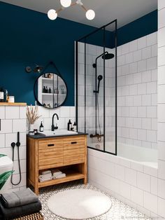 a bathroom with blue walls and white tiles on the floor, along with a wooden cabinet