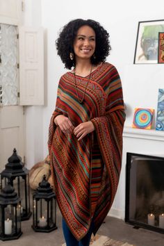 Alfredo Falcon of Peru designs this striped acrylic poncho with bold colors and a mixture of geometric motifs. A touch of baby alpaca gives adds to the poncho's warmth and feel. Lightweight the poncho makes a wonderful layering piece. Alfredo Falcon learned the craft of weaving from his parents who learned from their parents before them. He says âWe have been a family devoted to the world of textiles for generations. I use modern colors but I remain true to Incan and colonial motifs.â Poncho Winter Outfit, Winter Poncho Outfits, Peru Clothes, Long Poncho, Poncho Outfit, Hand Knit Poncho, Boho Poncho, Patchwork Scarf, Knit Poncho