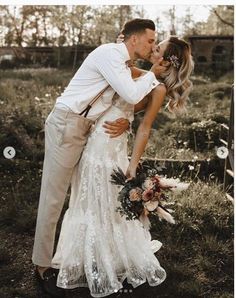 a bride and groom kissing in the grass