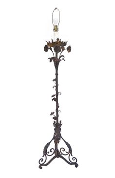 an iron floor lamp with flowers on it