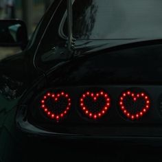 the tail lights of a car with hearts on them