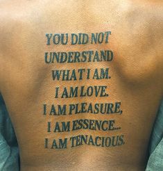 the back of a man's tattoo with words written on it