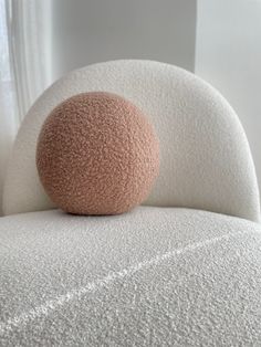 a round object sitting on top of a white chair