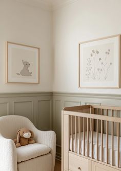 a baby's room with a chair, crib and pictures on the wall