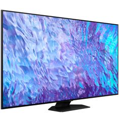 a flat screen tv on a white background with blue and purple paint swirling over it