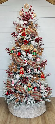 a christmas tree decorated with red, white and gold ornaments