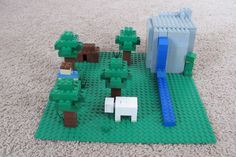 a lego set with sheep and trees on the ground