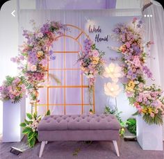 a bench with flowers on it in front of a backdrop