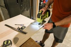 a man is sanding the table with a power drill and a cordless jig saw