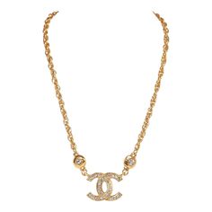 This vintage Chanel necklace in 24K gold plated metal has an interlocking CC logo hanging pendant with crystal detailing, a woven rope chain and a spring ring closure. Origin: FranceCollection: 1980sCondition: Vintage; Excellent. Minor signs of wear, including light scratching, pitting, and tarnishing near the chain links.Accompanied by: Chanel boxMeasurements: 16" chain, 1.5" x 1" pendant Vintage Luxury Chain Jewelry, Logo Necklace, Chanel Box, Chanel Chain, Chanel Necklace, Chanel Jewelry, Chain Links, Hanging Pendant, Cc Logo