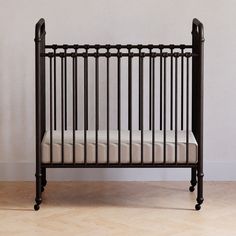 a black crib against a white wall