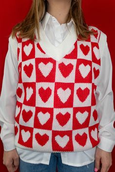 DETAILS: V-neck Sleeveless Lightweight True to size Carleigh is 5'2" with a 26" waist + 34B bust and is wearing a small. FABRIC: 100% Acrylic Heart Sweater Vest, Red Heart Sweater, Vest Sweaters, Heart Sweater, Sweater Vest, Red Heart, Stylish Outfits, Red White, Red And White