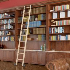 a ladder leaning up against a bookshelf in a room filled with wooden shelves