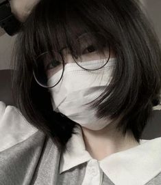 a person with glasses and a mask covering their face