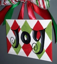 a christmas ornament hanging from the side of a door with ribbon on it