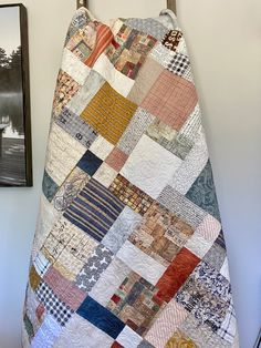 a quilt hanging on a hook in a room