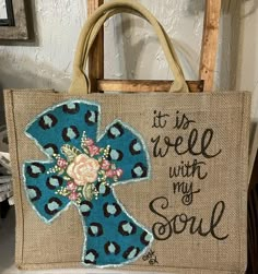 A hand painted Burlap Tote Bag.  Leopard Design Cross with Bible Verse:  It is well with my Soul. Color of Cross can be customized as well as the Verse.  Initials can be added also.   Free Shipping on this item. item needs to be ordered by December 10th for Christmas delivery Painted Bags Canvas, Burlap Bags Ideas Projects, Everyday Burlap Tote Bag, Bible Bags Totes Diy Paint, Cross With Bible Verse, Hand Painted Burlap Bags, Jute Bags Design Handmade Painting, Bible Tote Bag Painting Ideas, Christian Tote Bag Design Diy Paint