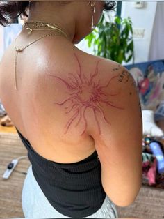 a woman with a tattoo on her back