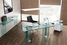 a glass desk with a laptop on it