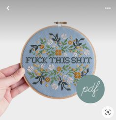 a hand is holding up a cross - stitch hoop with the words fix this seat on it