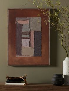 a painting on the wall above a table with vases and a potted plant