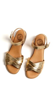 Metallic straps maximize the modern glamour of a go-to sandal set on a low block heel. 1 1/2" heel Adjustable ankle strap with buckle closure Leather upper and lining/synthetic sole Made in Spain Penelope Chilvers, Tory Burch Handbags, Strap Sandals Women, Round Bag, Jean Accessories, Denim Accessories, Designer Clothes For Men, Gold Leather, Metallic Leather