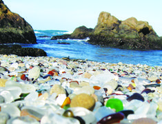 there are many different colored glass pebbles on the beach