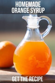 an orange syrup in a glass jug with the words homemade orange syrup get the recipe