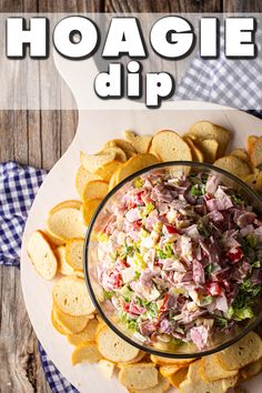 a white plate topped with chips next to a bowl filled with coleslaw dip