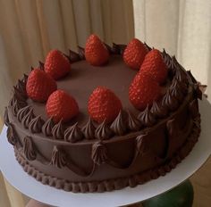 there is a chocolate cake with strawberries on top