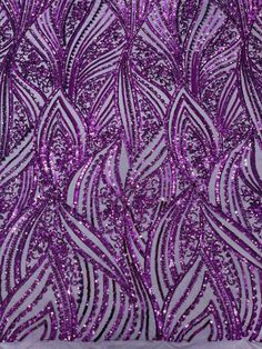 purple sequins on fabric with wavy lines and curves in the center, as well as an intricate design