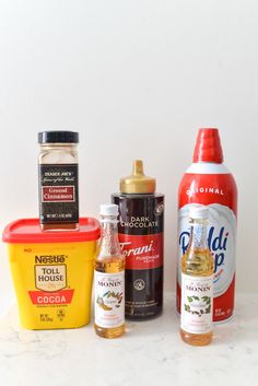 an assortment of condiments are displayed on a counter top, including mustard and seasonings