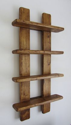 a wooden shelf that has three shelves on each side and one is made out of wood