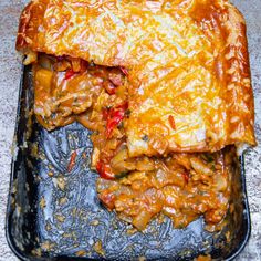 a casserole dish with meat and cheese on it