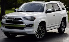 a white toyota 4runner is parked on the street