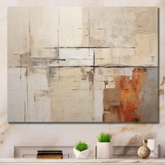 an abstract painting on the wall in a living room with white vases and books