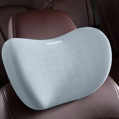 an inflatable pillow sitting on the back of a car's headrest