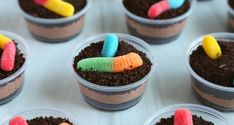 cupcakes with candy worms in them on a table