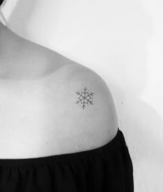 a woman with a snowflake tattoo on her shoulder