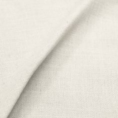 closeup of white fabric textured with fine linens for curtains and upholstering