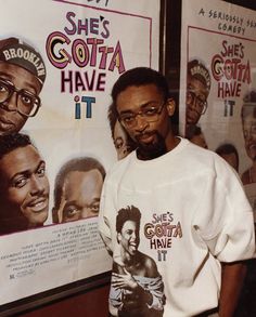 a man is standing in front of some posters