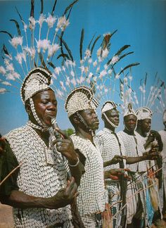 an image of some people that are wearing headdresses and standing in front of each other