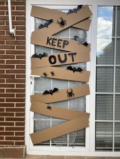 a door decorated to look like it has been cut out with tape and some bats