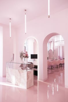 an office with pink walls and marble desks