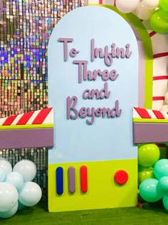 there is a sign that says to infant three and beyond next to balloons in the background