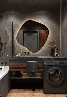 a washer and dryer in a bathroom with wood flooring on the walls