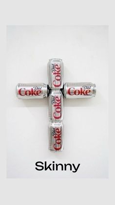 the cross is made out of four cans of coke and says skinnyy on it