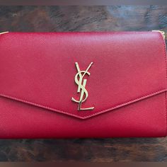 Ysl Red Uptown Wallet On Chain Grain De Poudre Retail $1,490 Stunning Wine Red Grain. I Purchased This At Neiman Marcus And I Am Selling It Because I Do Not Use It. A Great Buy! Strap Is Red Grain And Can Be Placed In Purse To Use As A Clutch. I Have Used It Both Ways. Saint Laurent Wallet In Powder-Grain Calf Leather This Wallet Comes With Leather Strap That Can Be Stored Inside Bag Envelope Flap With Metal Ysl Monogram, Snap Closure Interior Slip Pocket Approx 4.7”H X 7.4” W X 1.1” D Made In Italy Saint Laurent Wallet, Yves Saint Laurent Bags, Inside Bag, Wallet On Chain, Wine Red, Snap Closure, Calf Leather, Neiman Marcus, Yves Saint Laurent